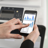 Close-up Of Businesswoman Giving Print Command On Smart Phone